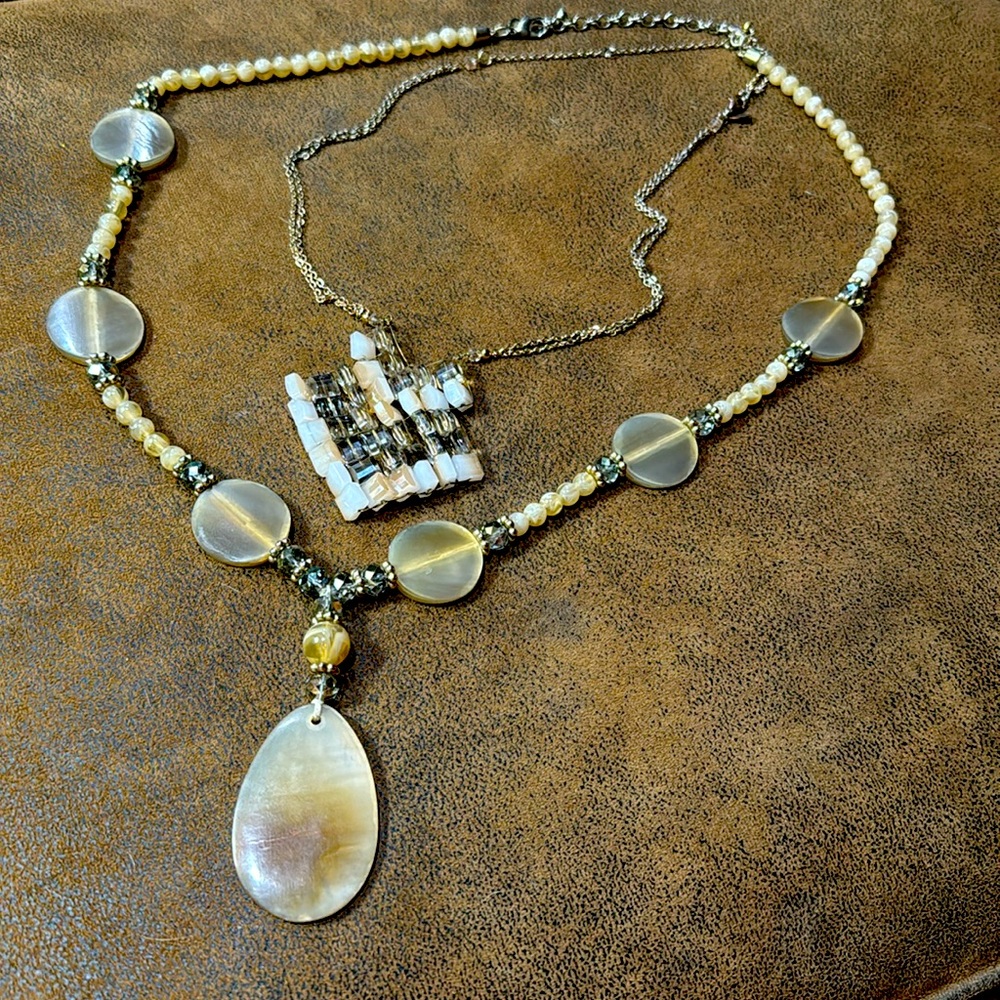 Chicos necklaces with tan beads and light green crystals